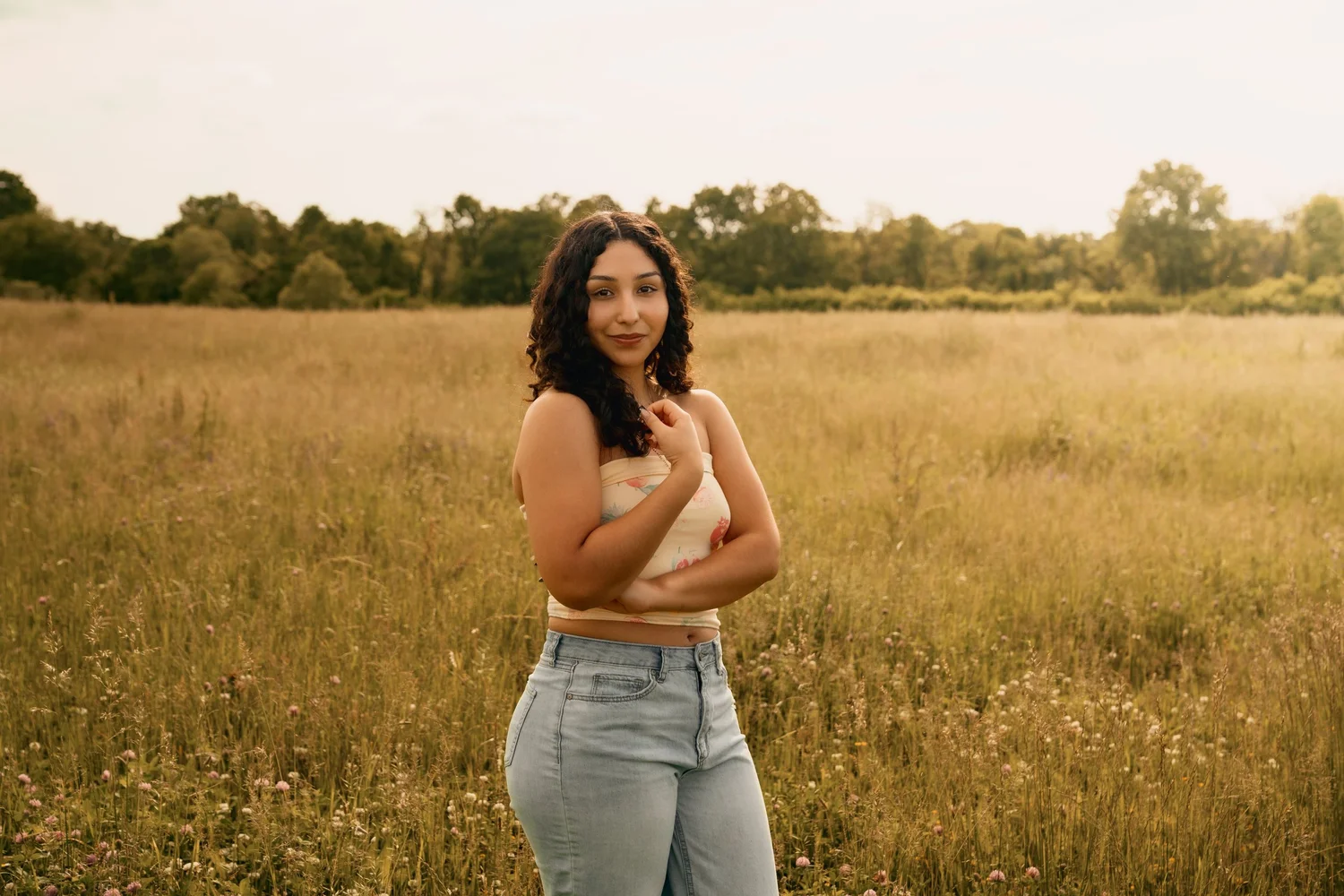 Senior portrait photographed in a field by LY Photography Co