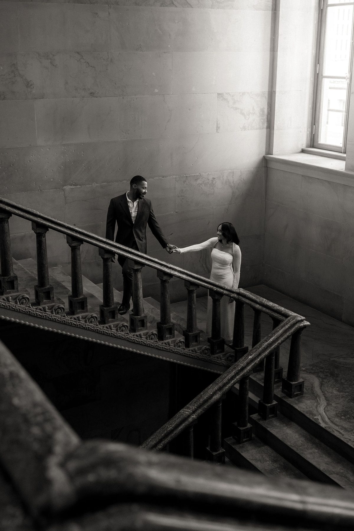 Kashiri and Chris photographed on a stone staircase by LY Photography Co