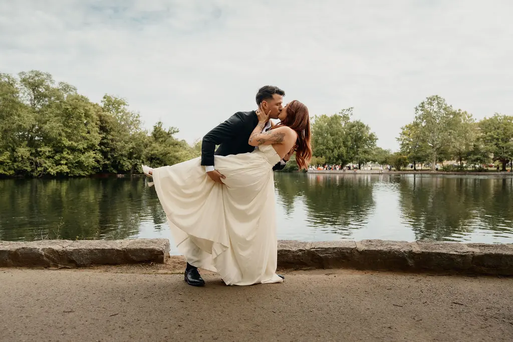 Mike dipping Ashley for a kiss at the water’s edge