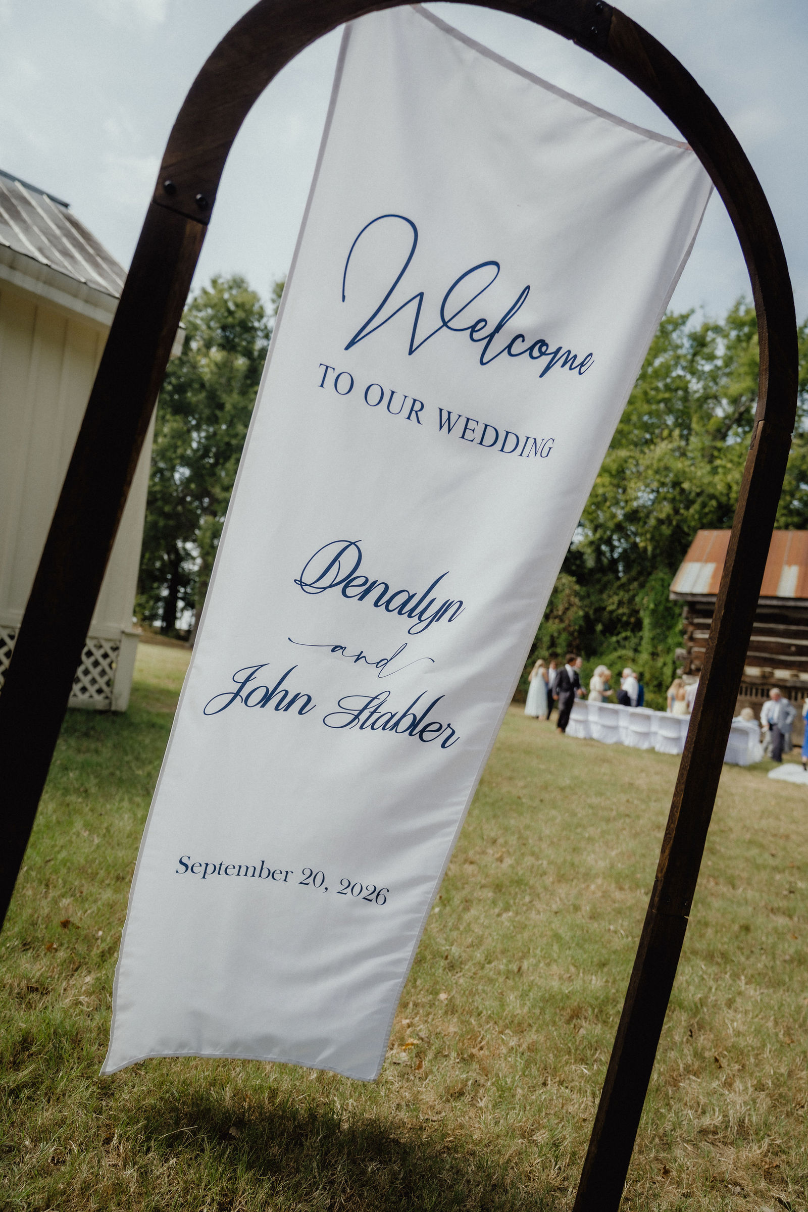 The welcome banner on the lawn reading Denalyn and John Stabler, September 20, 2026