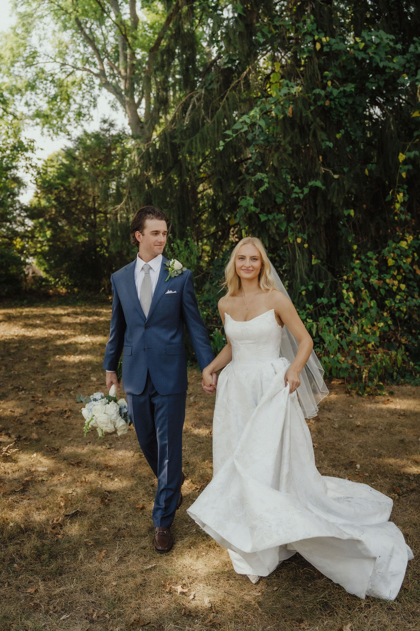 Walking together under the trees at the edge of the park