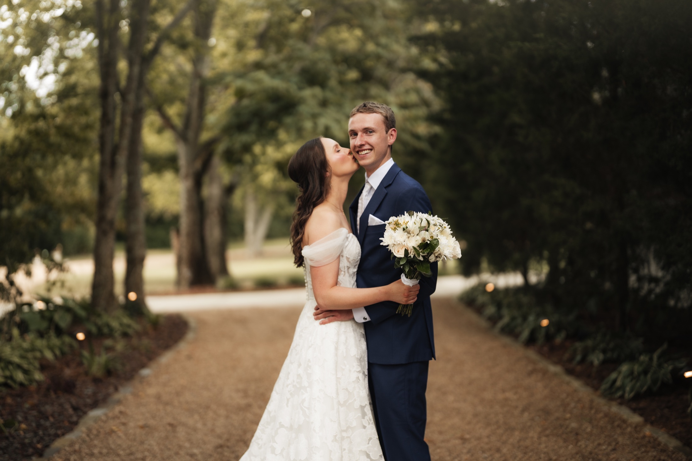 Katie and Zach walking together through the wooded grounds