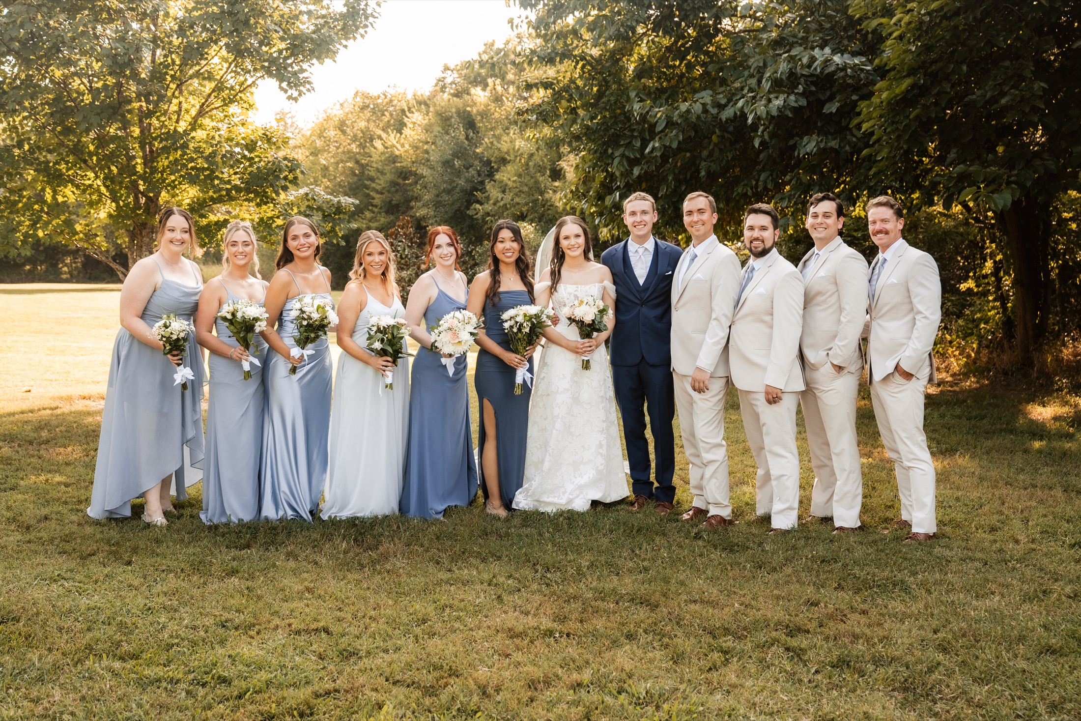 Katie and Zach with their wedding party dressed in soft blue