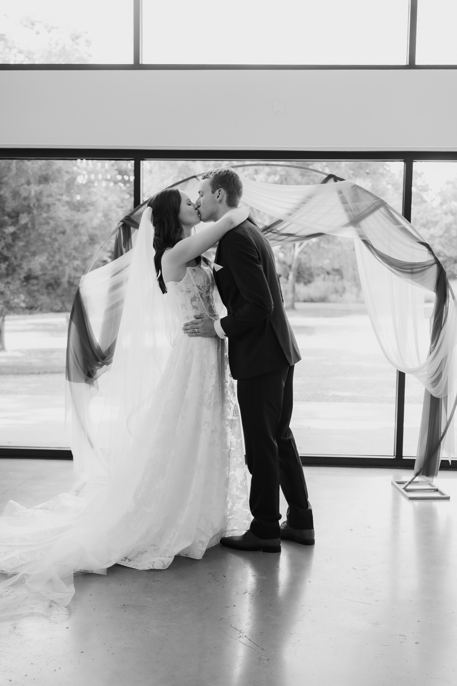 Katie and Zach kissing during their wedding ceremony