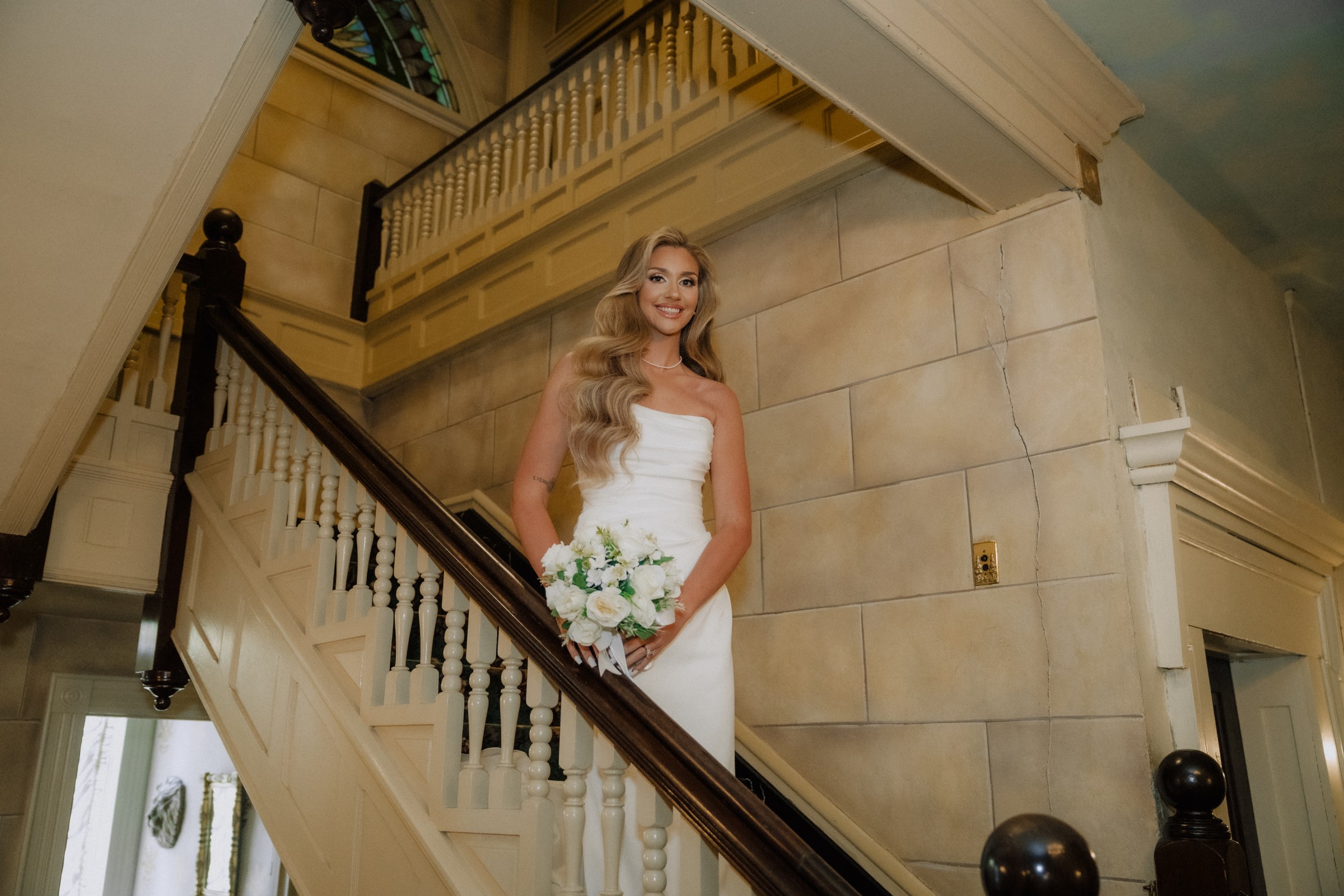 Maddie on the landing beneath the stained-glass window