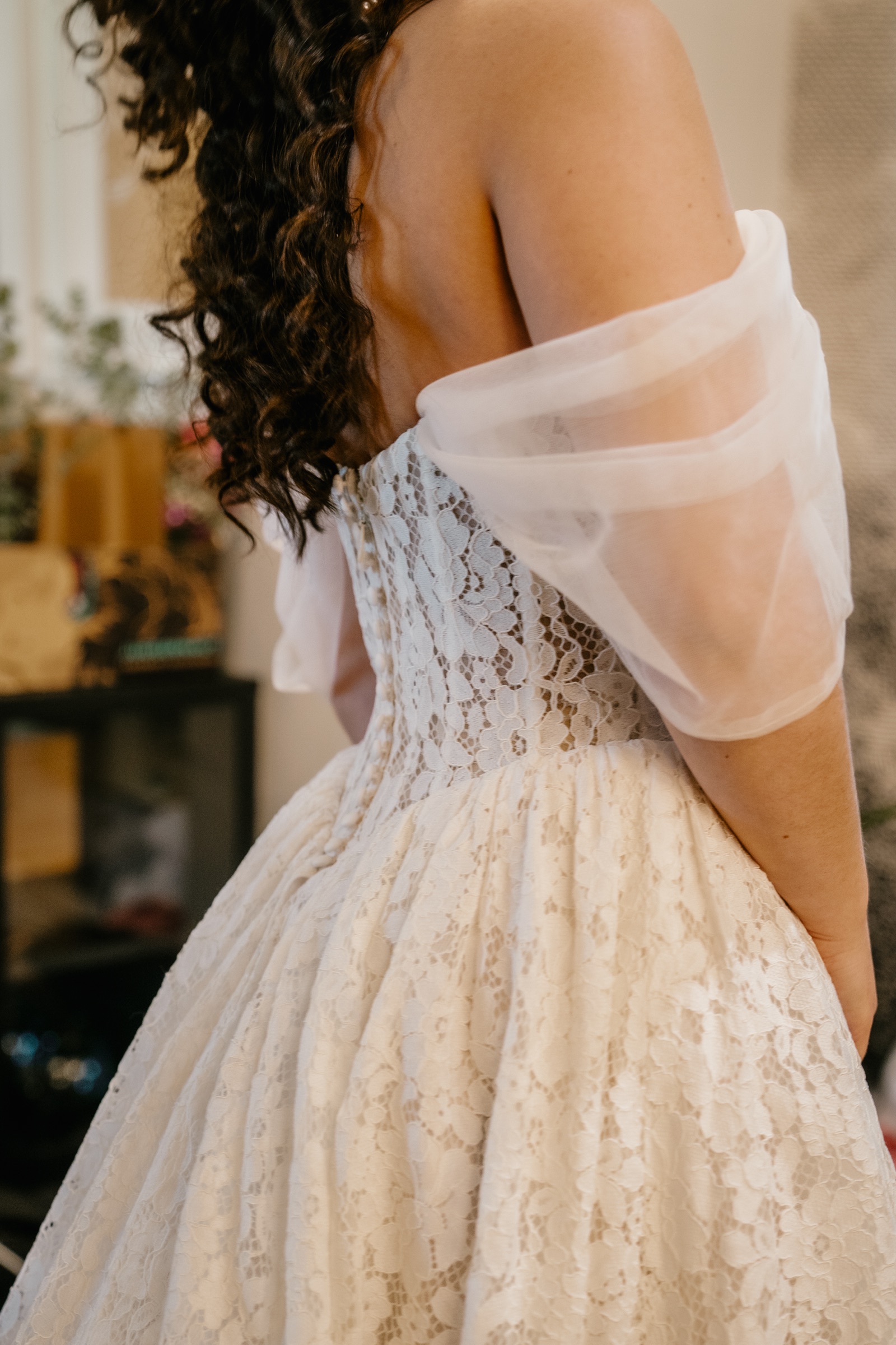 The corset back of Presley’s lace dress and her off-shoulder sleeves
