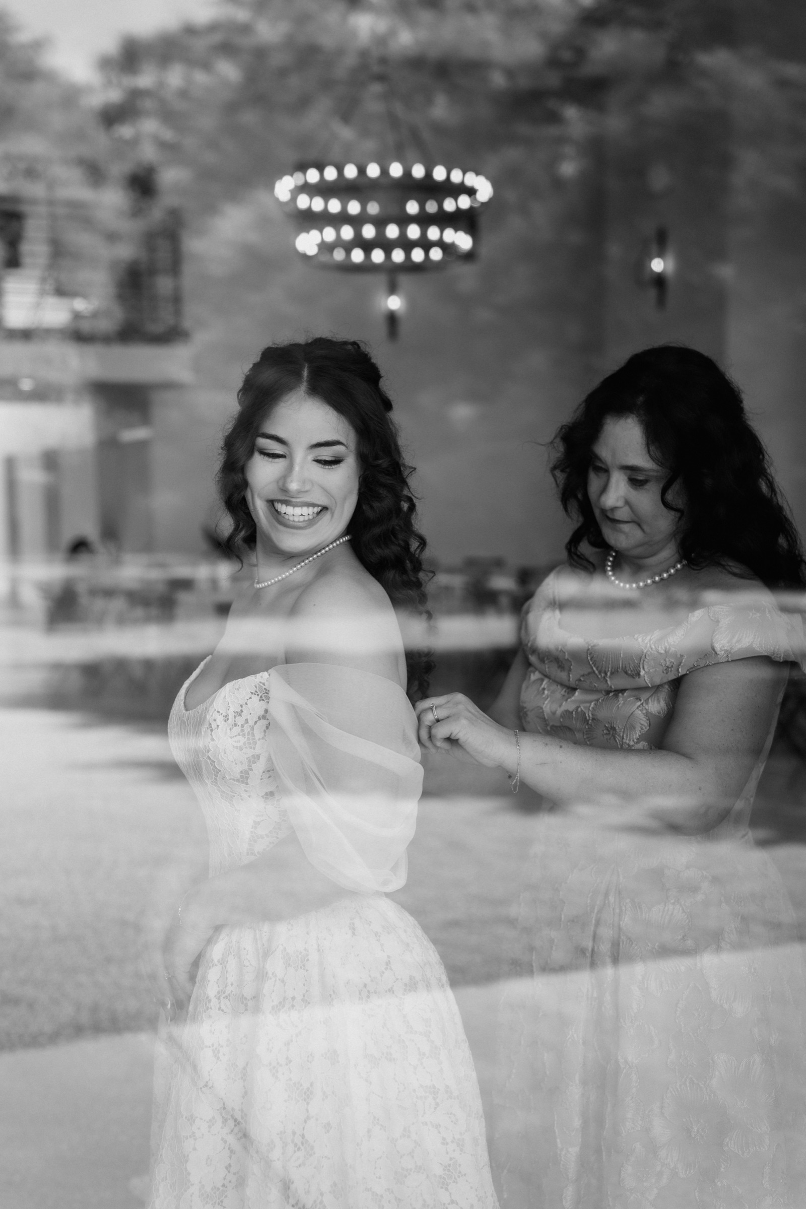 A double-exposure of Presley with her mother buttoning her dress