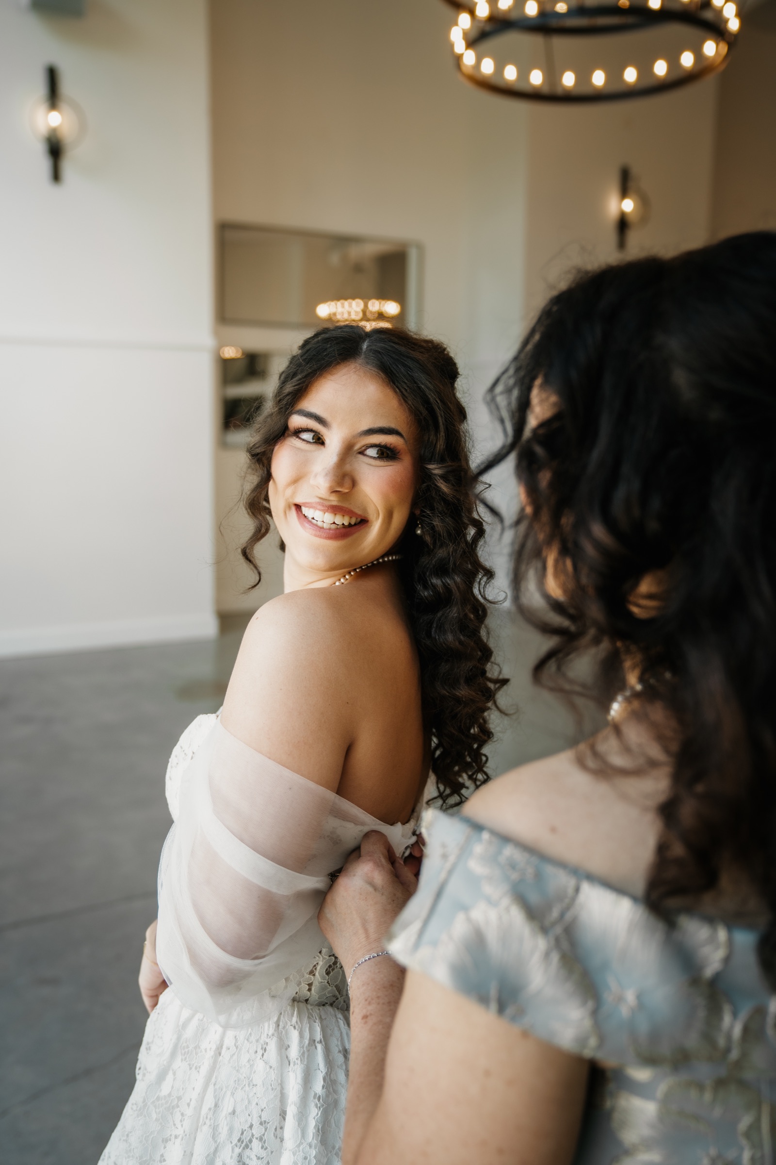 Presley smiling over her shoulder while getting ready