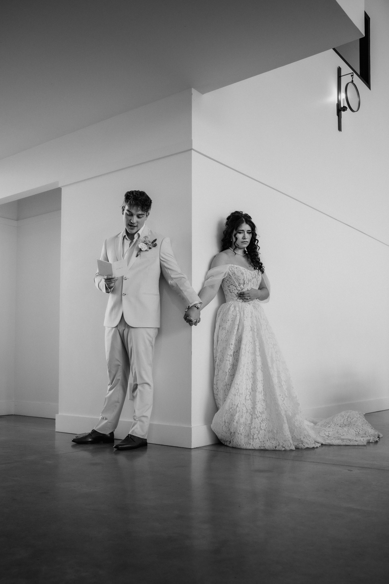 Presley and Jack holding hands around a corner during their first touch