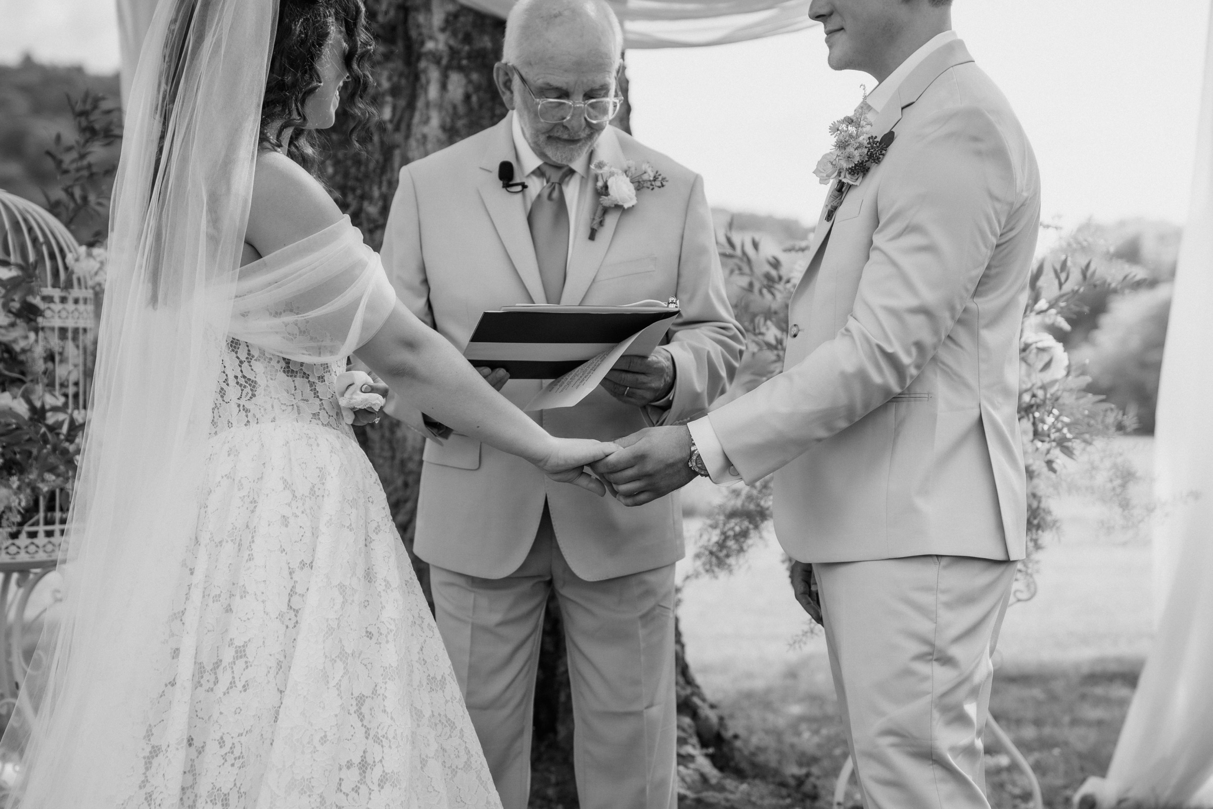 Presley and Jack exchanging vows in black and white