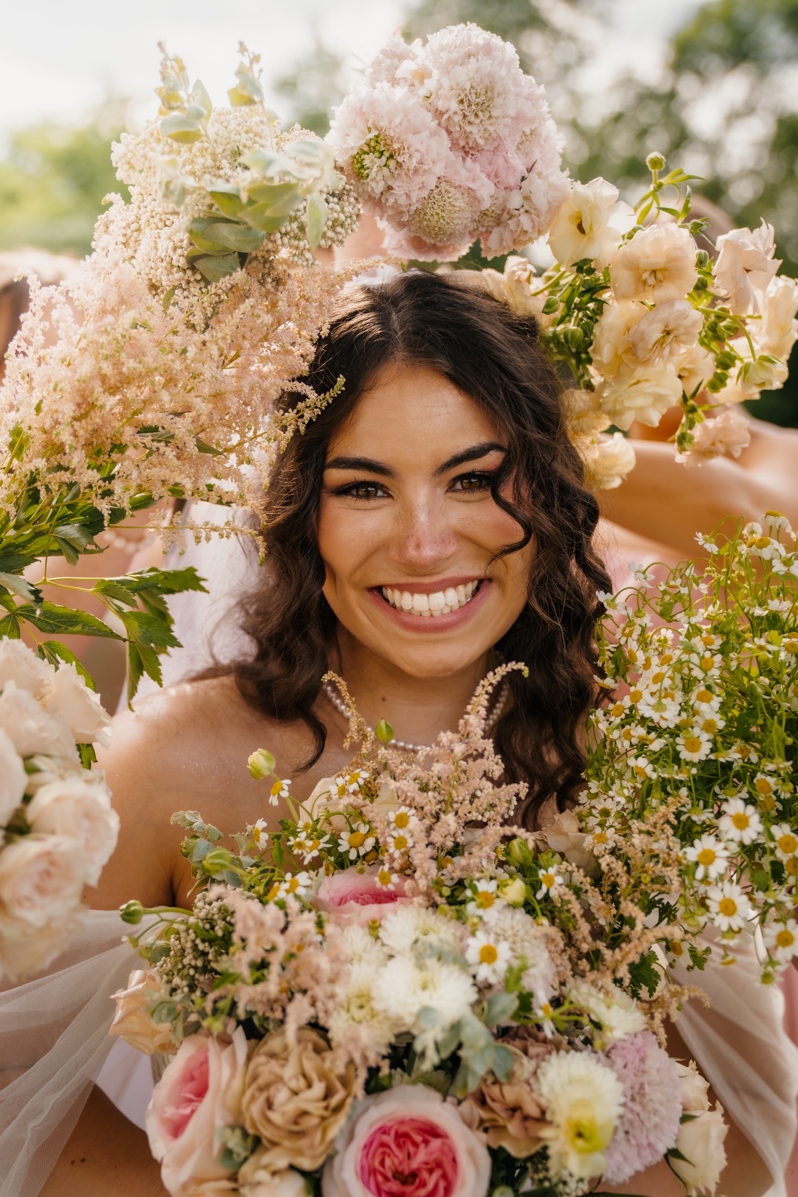 Presley beaming through her pink and cream bouquet