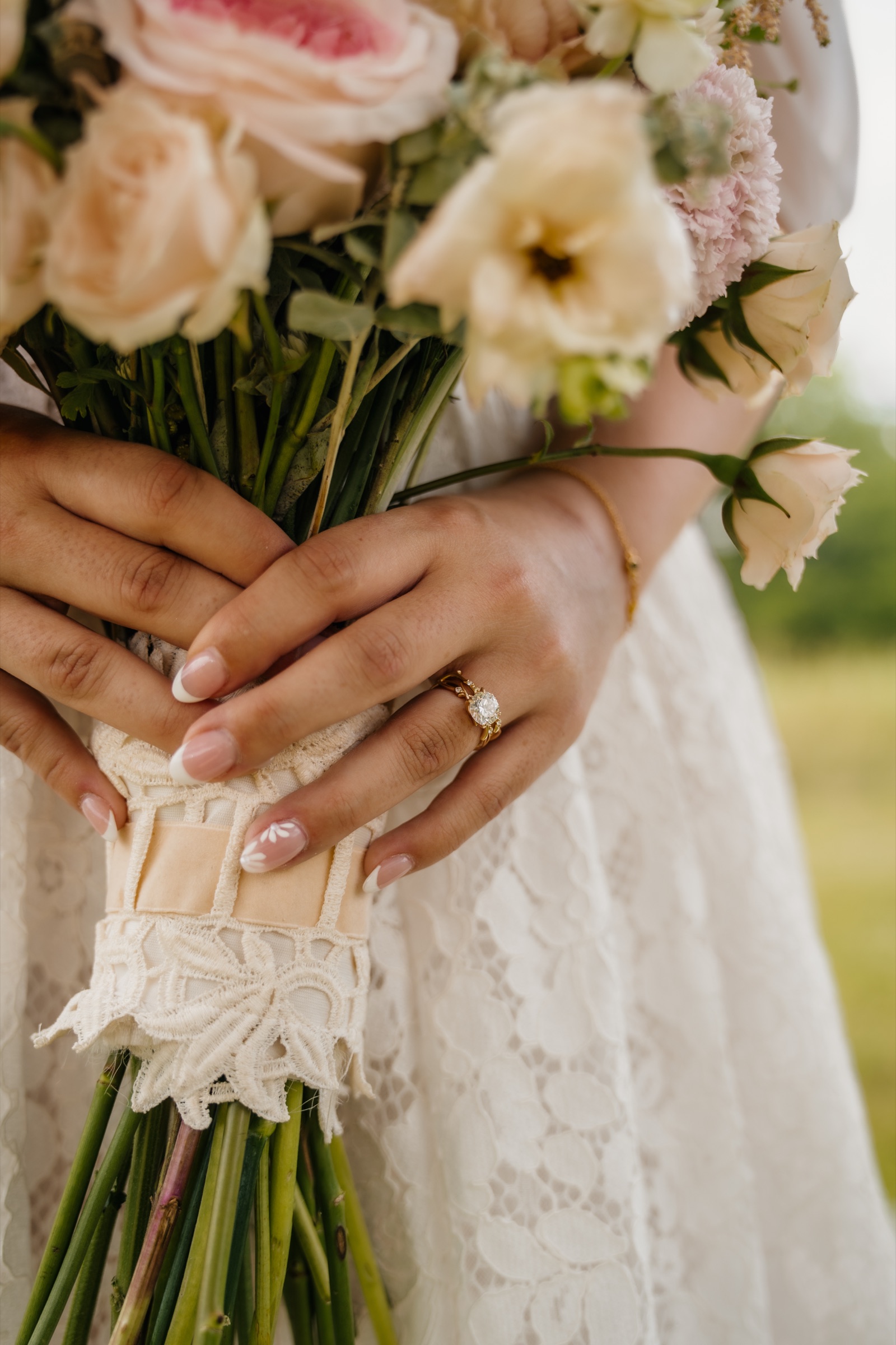 Presley’s ring and bouquet of pink and cream roses held close