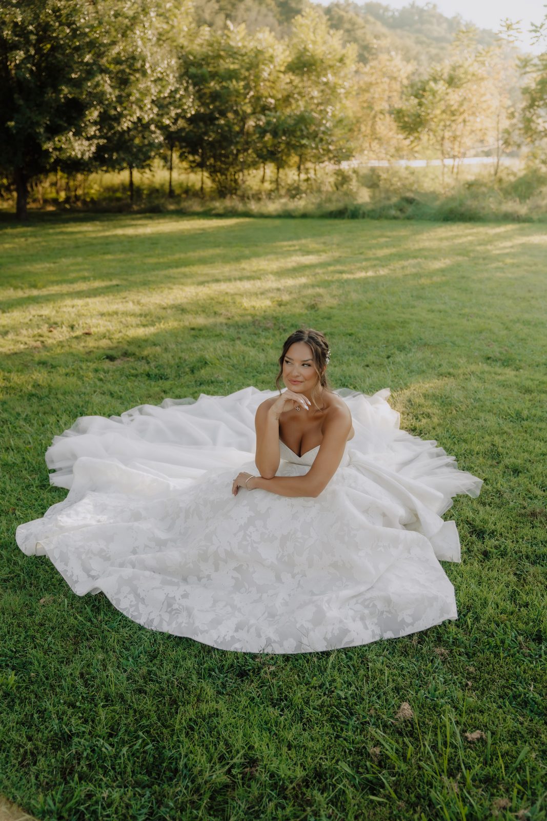 A bride on the open lawn at Drakewood Farm in the last of the evening light